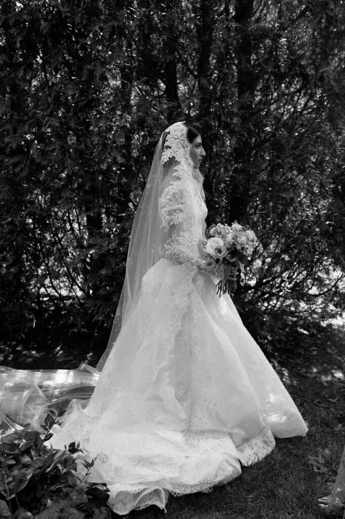 Vintage bride in lace dress in garden at Villa Terrace Wisconsin