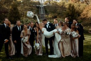 Villa Terrace Decorative Arts Museum Milwaukee, Wisconsin bride and groom having fun with bridal party