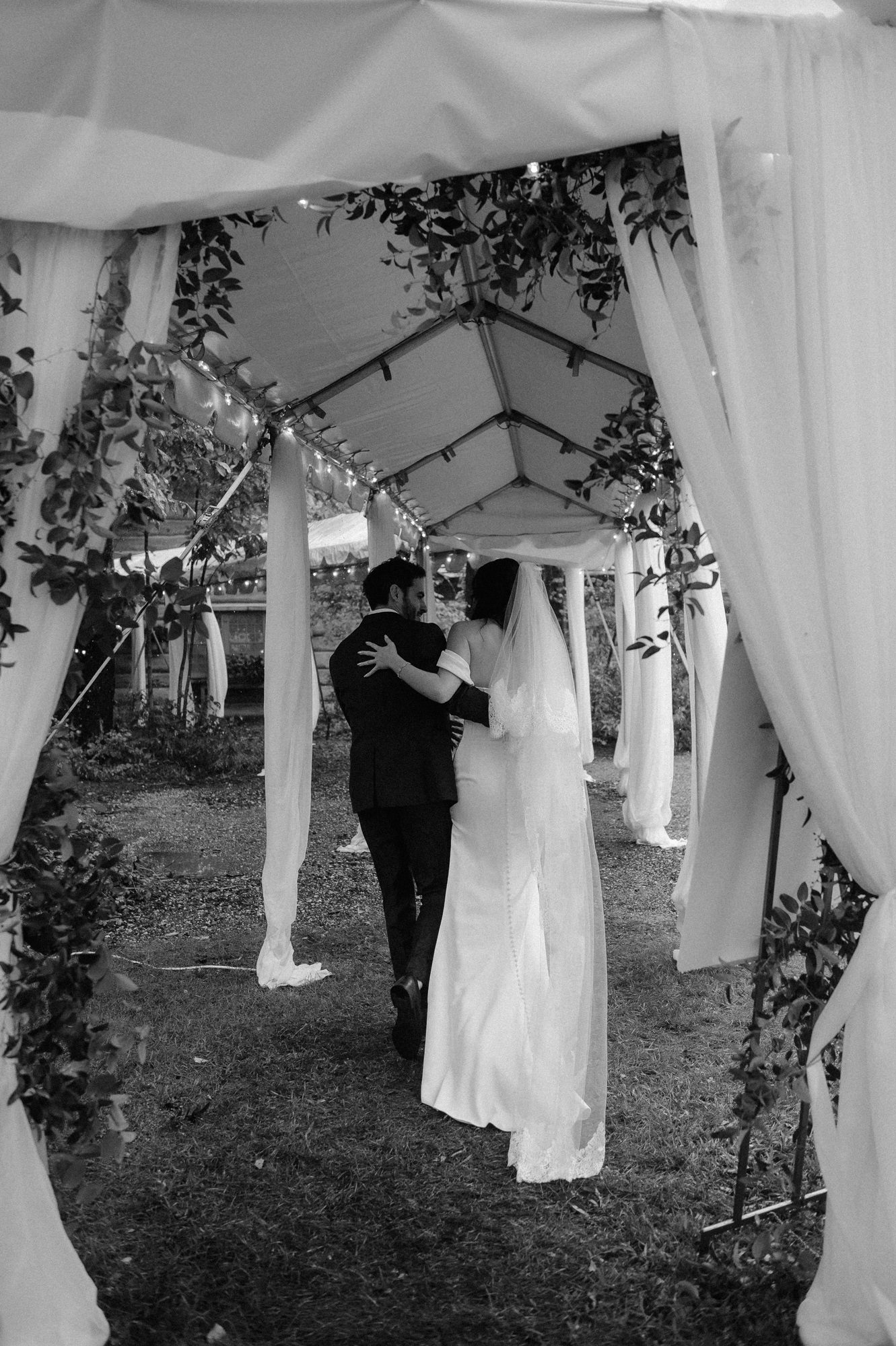 Bride and groom walk towards wedding reception at River Wildlife