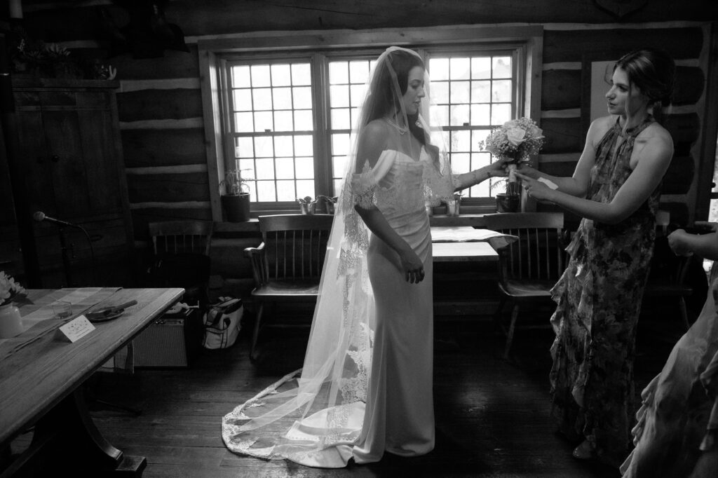 Bride and bridesmaid getting ready before wedding at River Wildlife