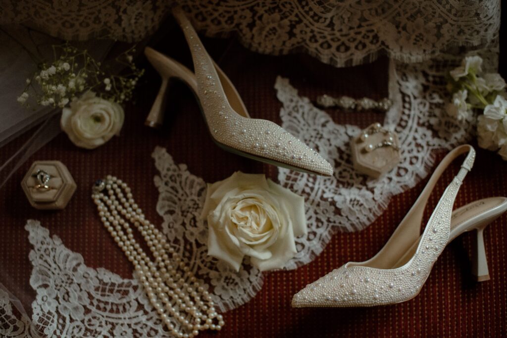 Bridal shoes and jewelry flatlay at River Wildlife in Kohler