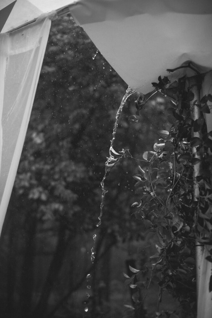 Rain coming off tent at River Wildlife wedding in Kohler
