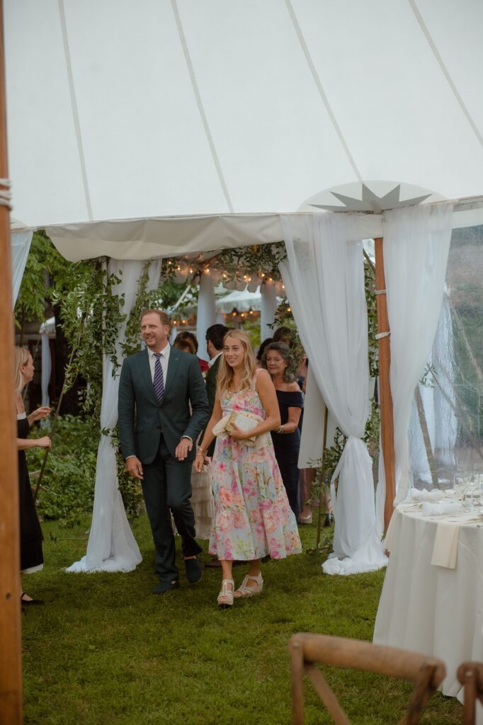 Guests arriving to outdoor tent wedding at American Club in Kohler