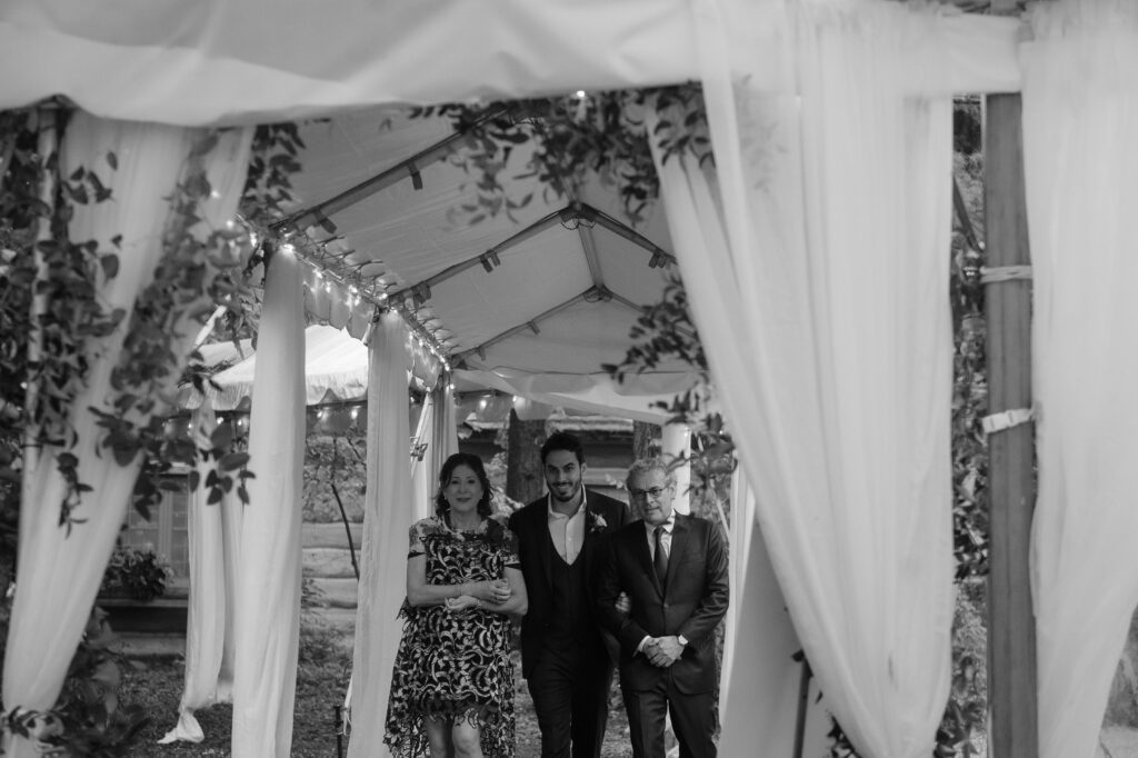 Groom walking down the aisle at River Wildlife wedding ceremony