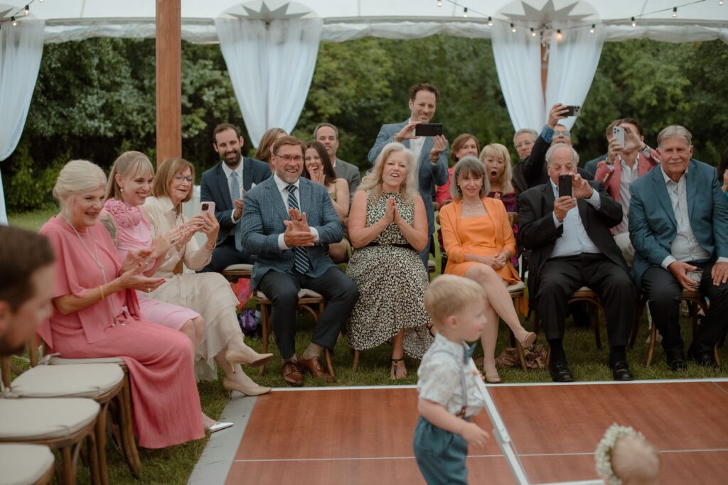 Guests clapping at River Wildlife wedding reception