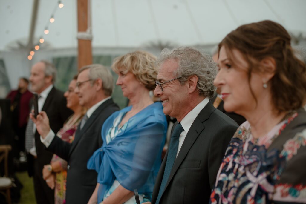 Guests watch wedding ceremony at River Wildlife, Kohler