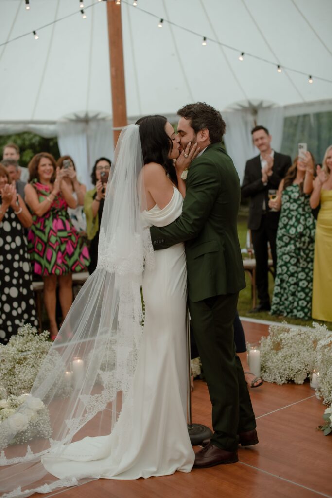 Bride and groom kiss at Kohler tent wedding ceremony