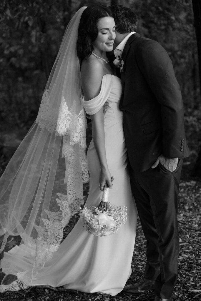 Wedding couple embraces outdoors at River Wildlife