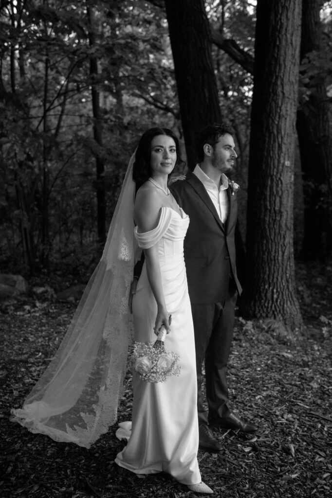 Black and white portrait of a bride and groom in the forest at River Wildlife in Wisconsin