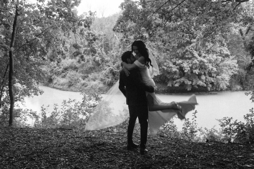 Groom spins bride by the river at River Wildlife wedding in Kohler, Wisconsin