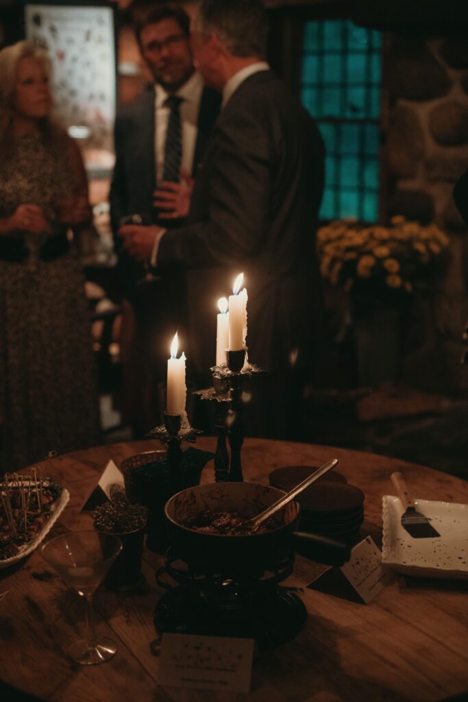 Candles burning as guests chat at River Wildlife wedding reception
