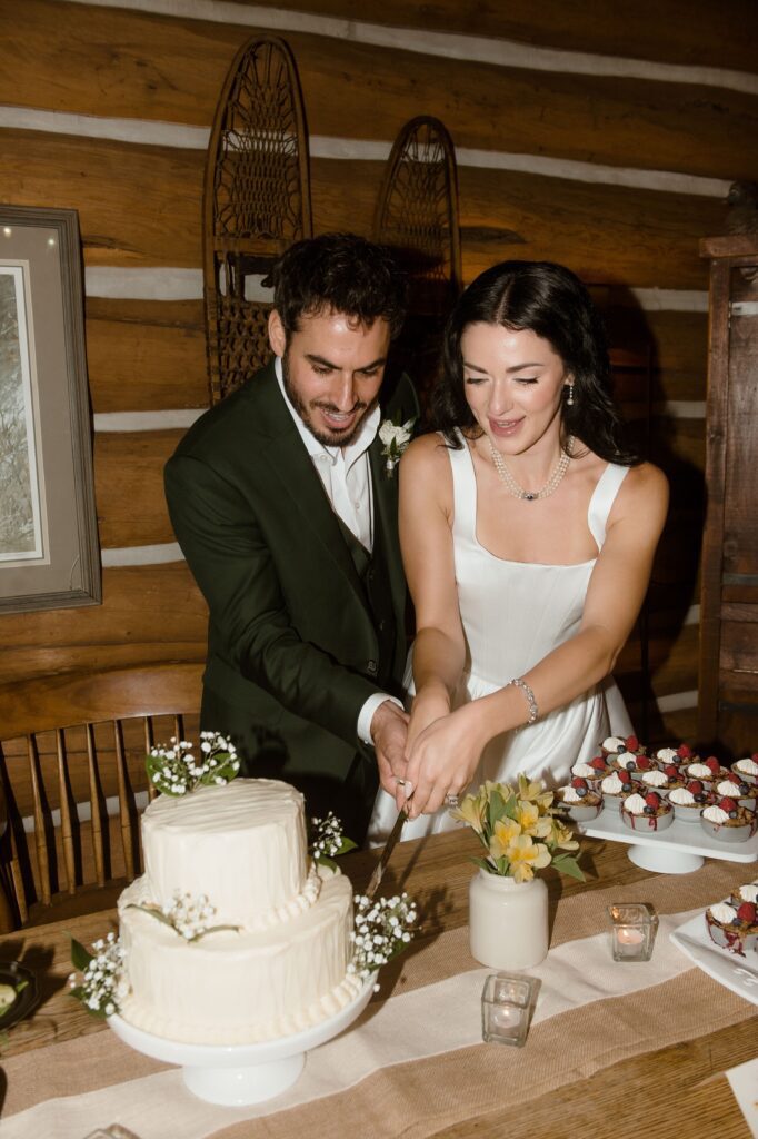 Bride and groom cut cake at wedding reception in Kohler, WI
