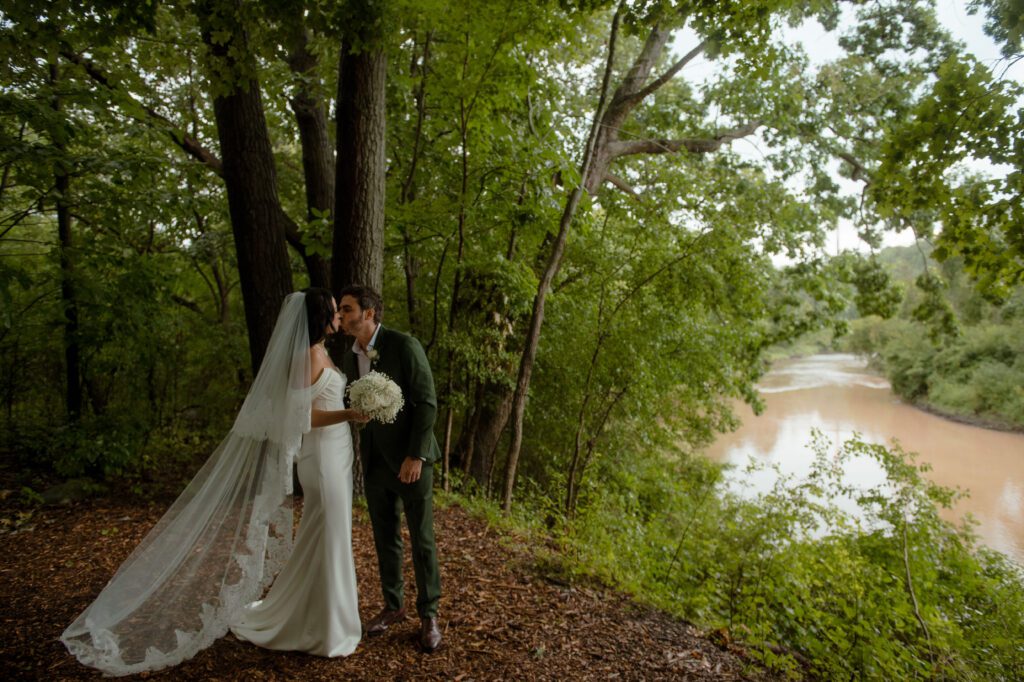 Couple kissing in the woods at River Wildlife in Wisconsin