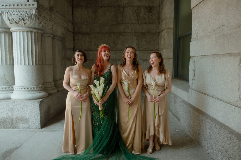 Bride and her bridal party laugh together at Pfister Hotel in Milwaukee