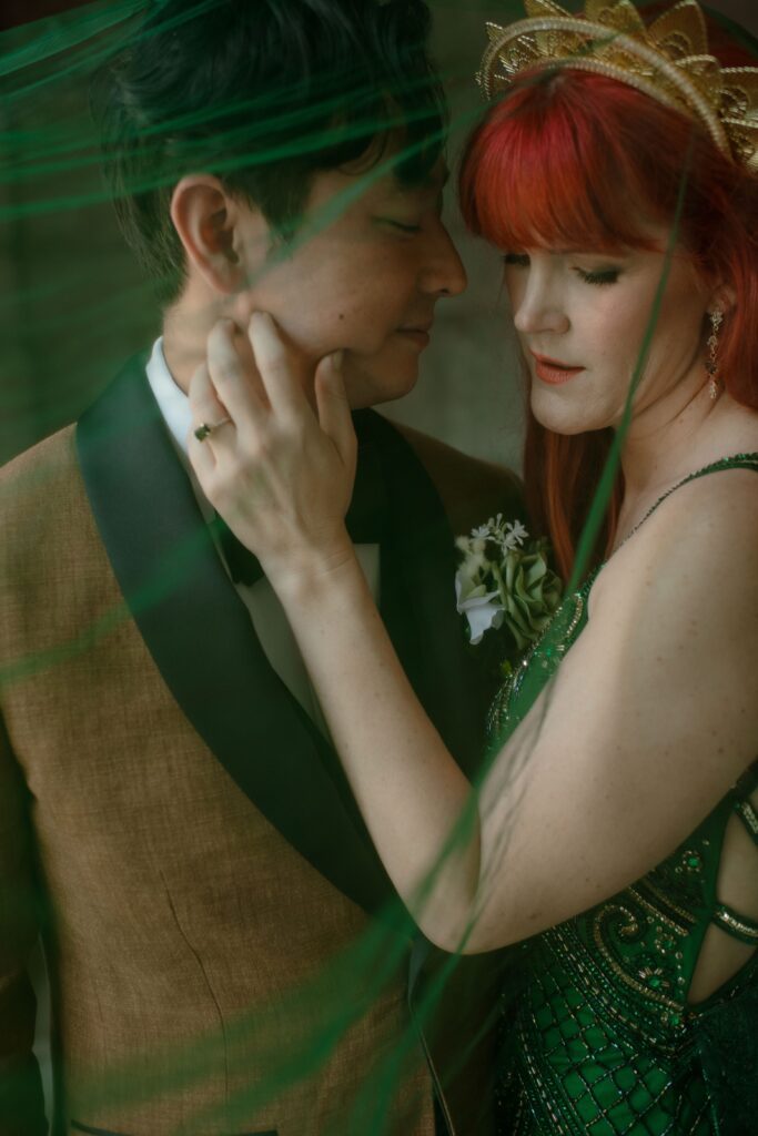 Bride touches grooms face in a couples portrait at Pfister Hotel in Milwaukee