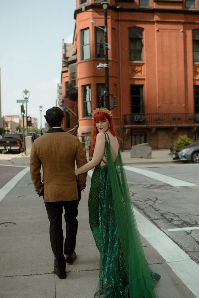Bride and groom walk the streets of Milwaukee on their wedding day