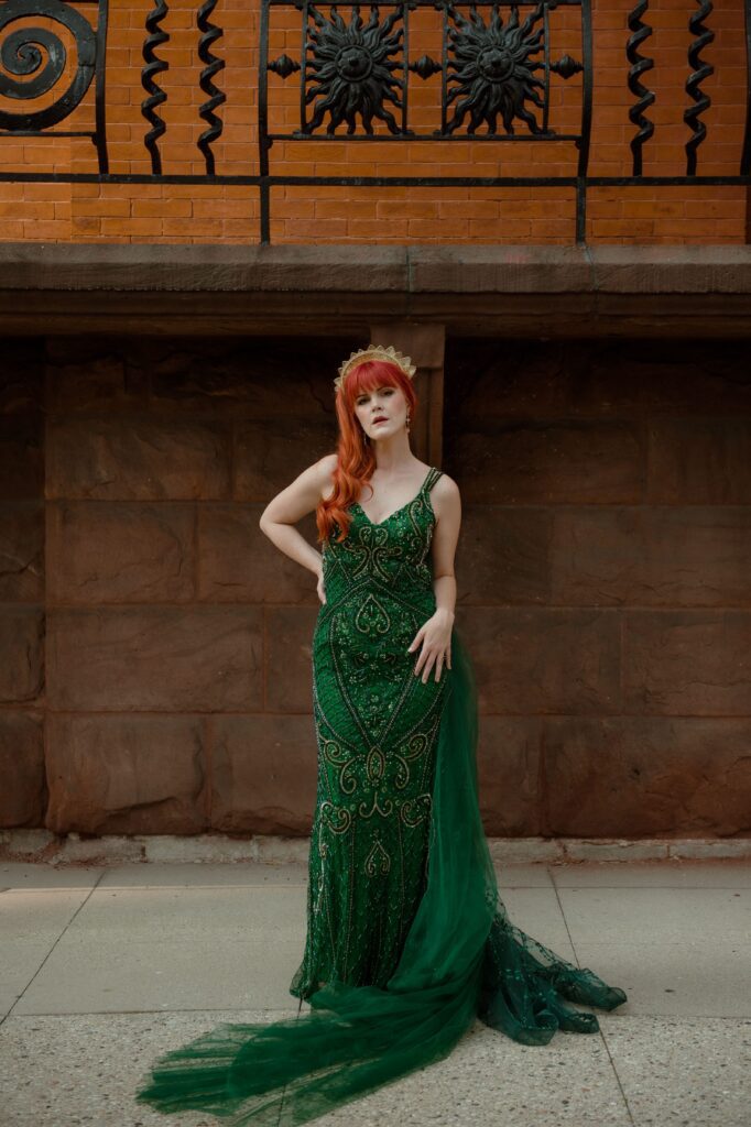 Redhead bride poses in her emerald green wedding dress in Milwaukee