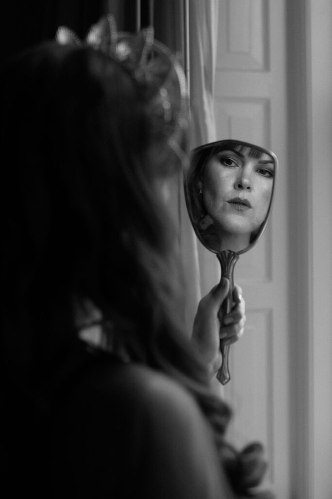 Bride looking in a mirror at Pfister Hotel in Milwaukee