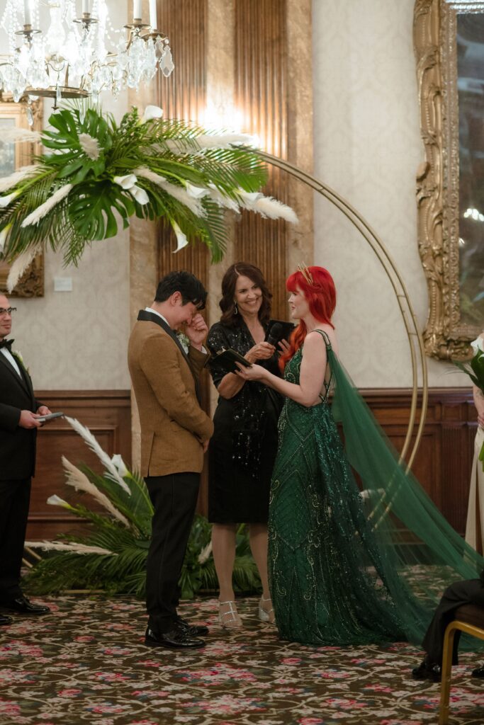 Bride and groom crying while reading vows at Pfister Hotel in Milwaukee