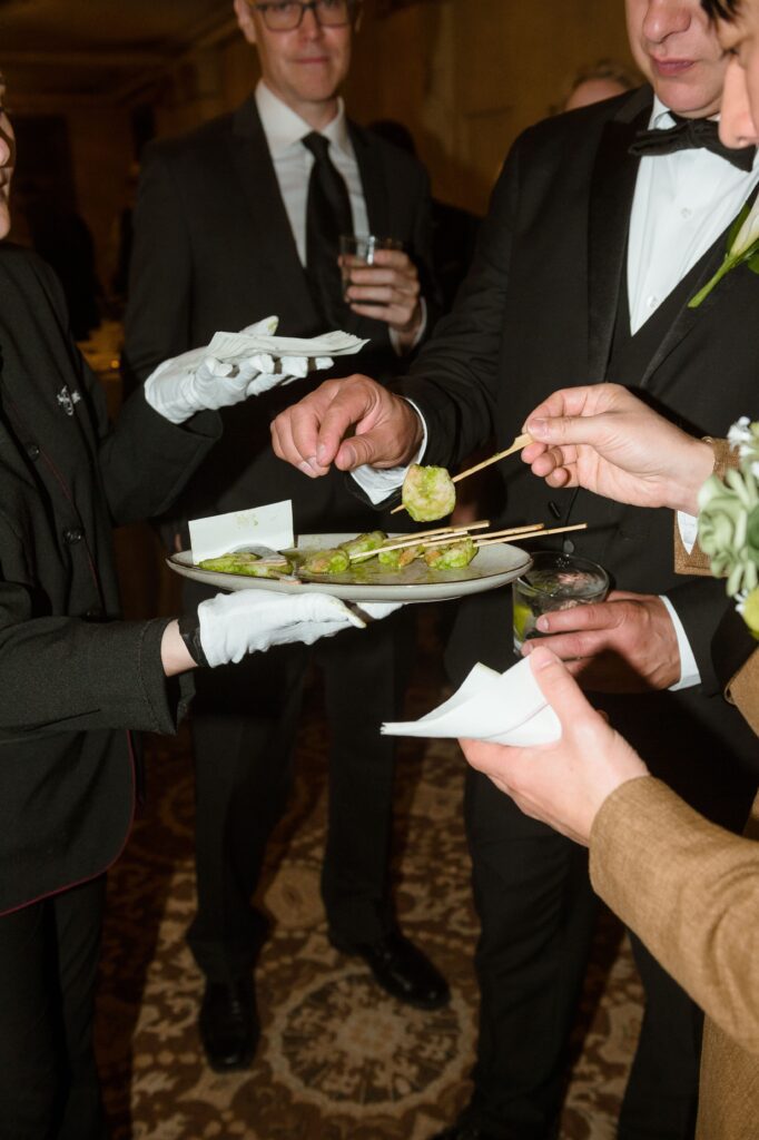 Guests eat hors d'oeuvres during cocktail hour at the Pfister Hotel in Milwaukee