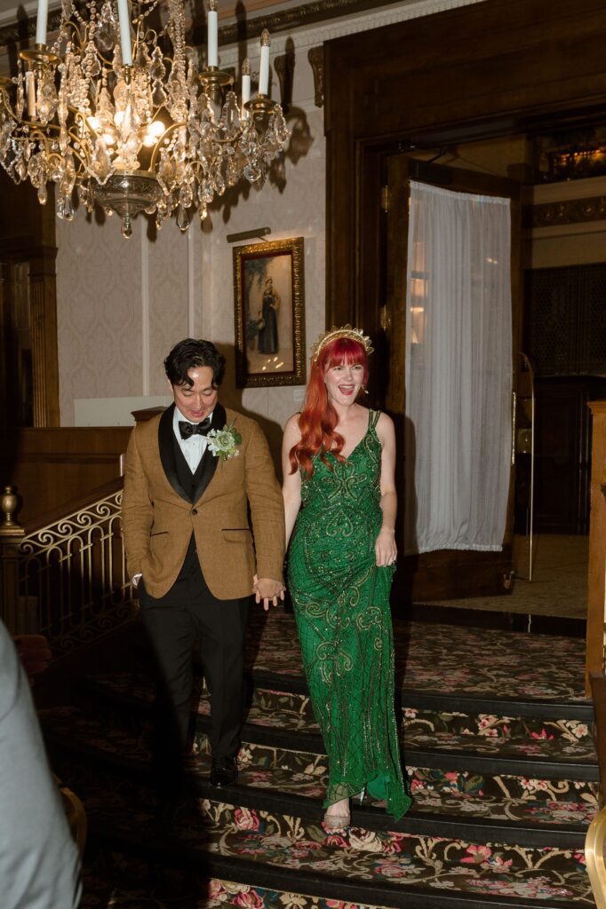 Bride and groom walk into their wedding reception at the Pfister Hotel in Milwaukee