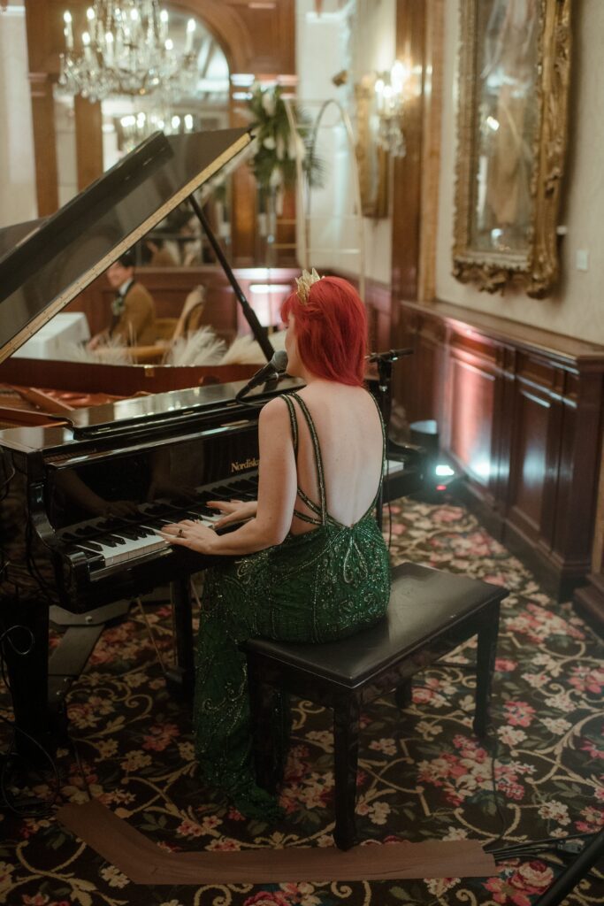 Bride plays the piano and sings at wedding reception at the Pfister Hotel in Milwaukee