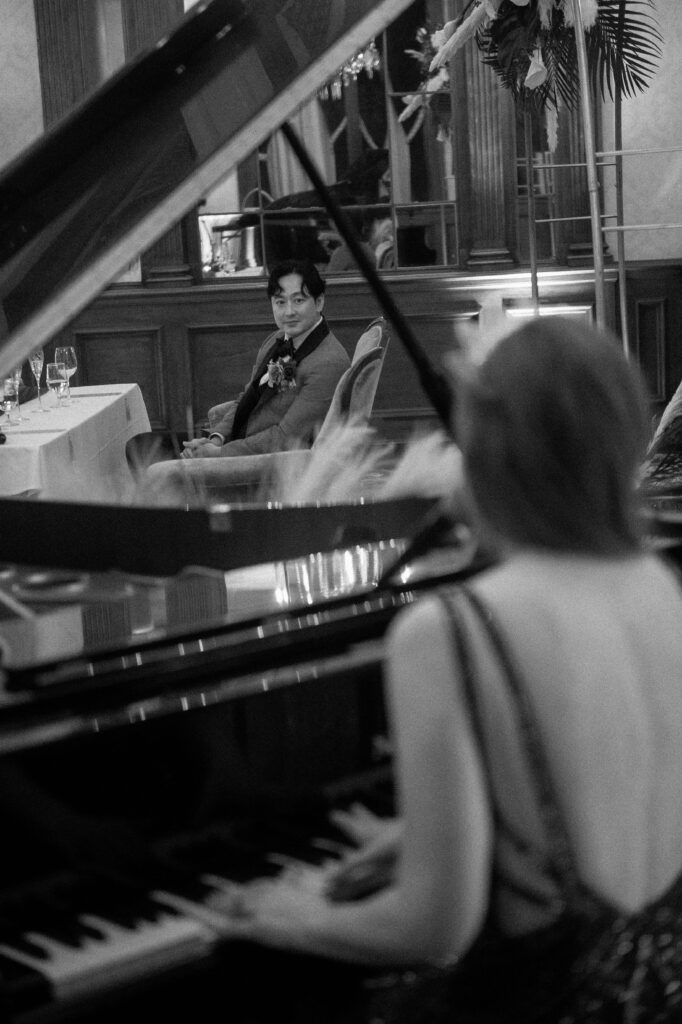 Groom watches his bride sing to him at the Pfister Hotel in Milwaukee