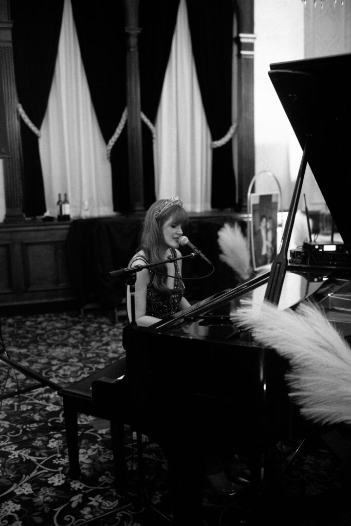 Bride sings and plays the piano at the Pfister Hotel in Milwaukee