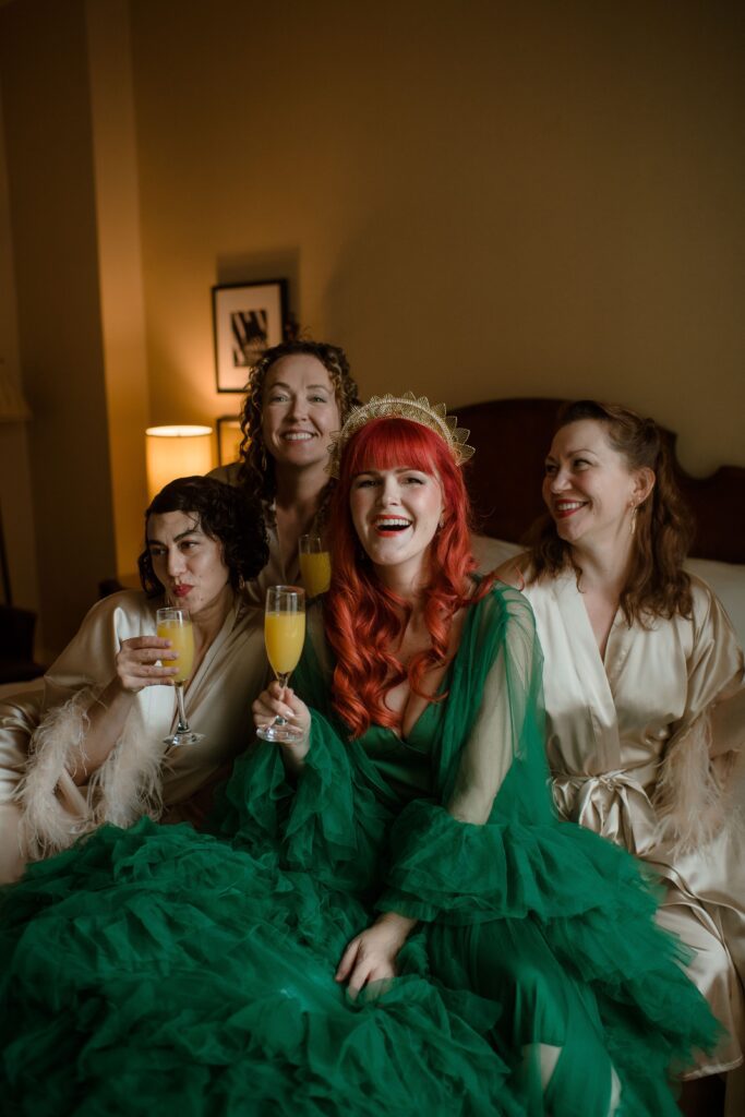 Bride with her bridesmaids in hotel room with champagne at Pfister Hotel in Milwaukee