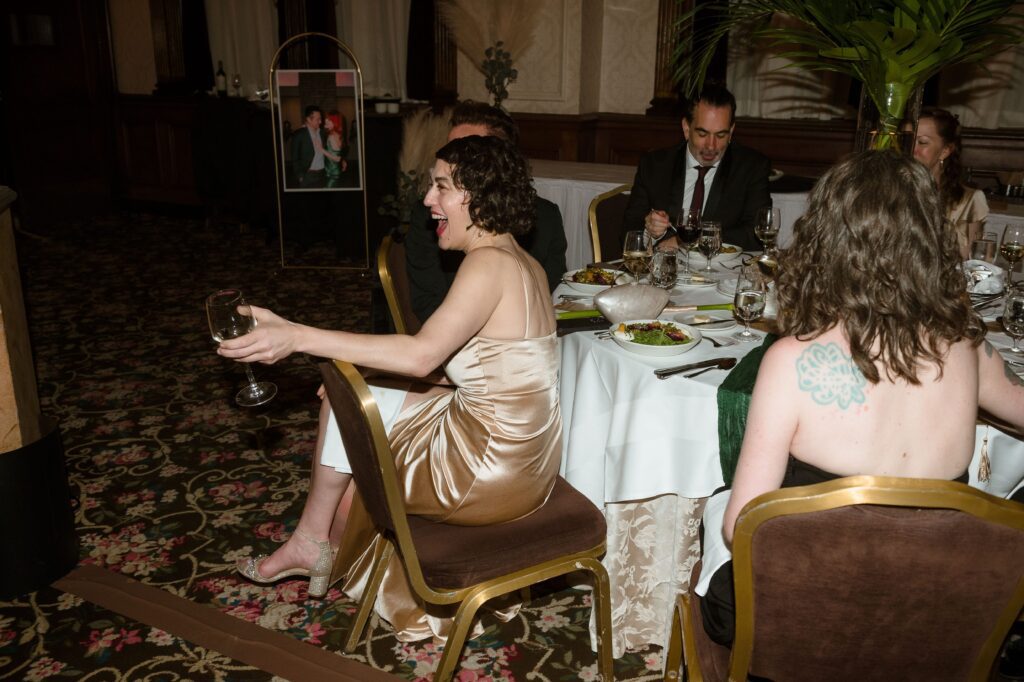 Guests laugh during wedding toasts at the Pfister Hotel in Milwaukee
