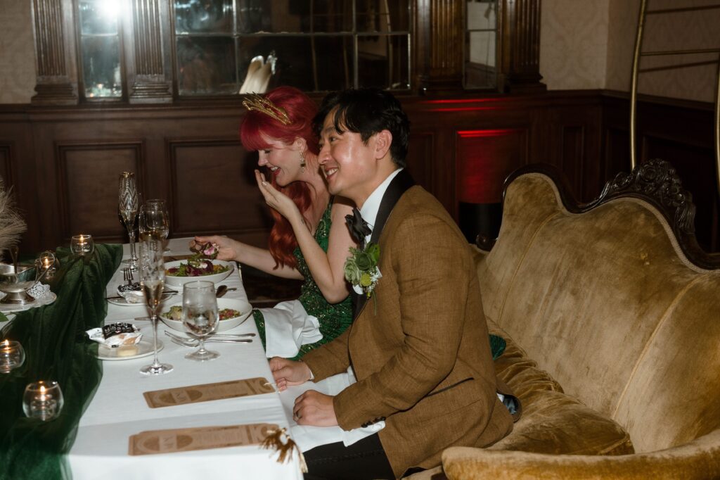 Bride and groom laugh during toasts during their wedding reception at the Pfister Hotel
