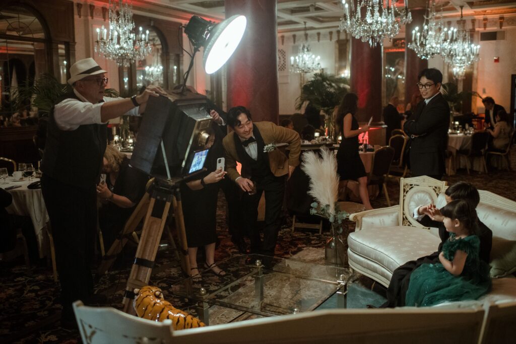 Guests take photos with a vintage camera at the Pfister Hotel