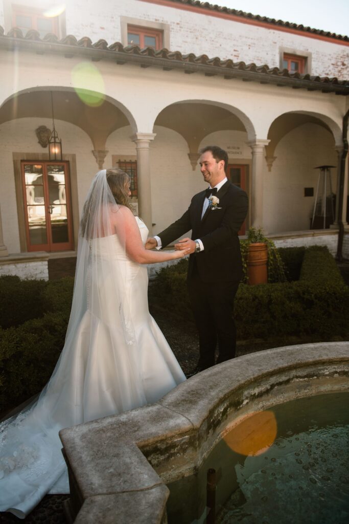 Bride and groom hold hands at Milwaukee wedding venue