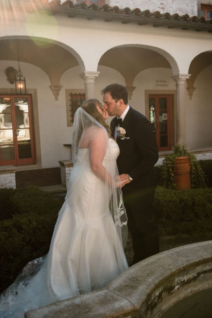 Bride and groom kiss at Villa Terrace