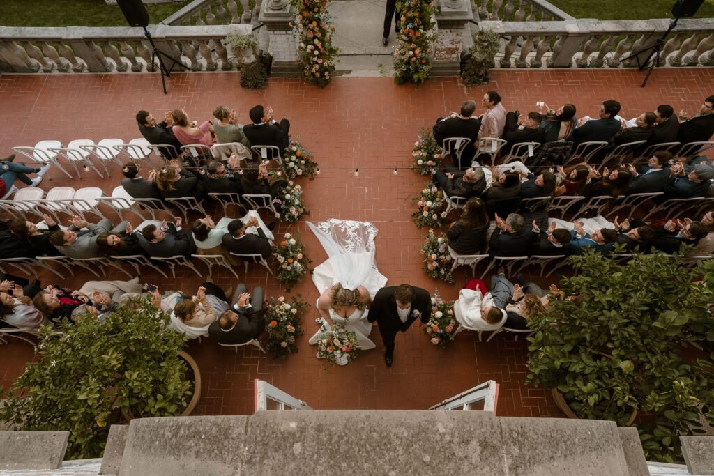Overhead shot of couple walking down the aisle after wedding ceremony