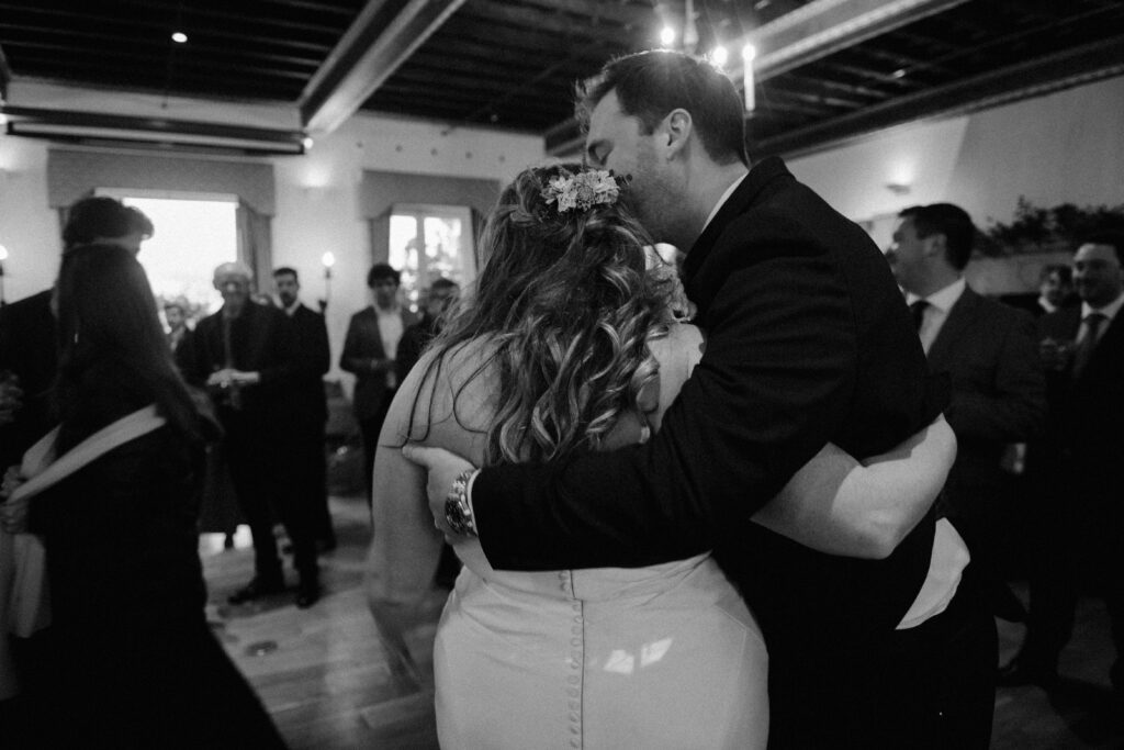 Groom kisses bride at wedding reception