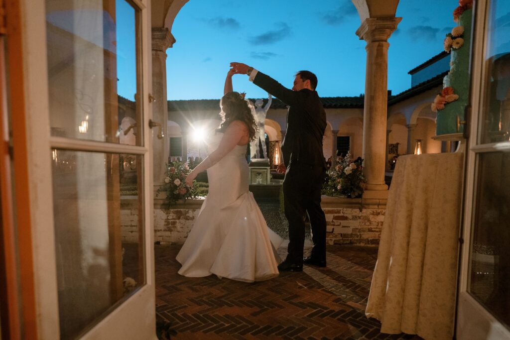 Bride and groom dance together outdoors at Villa Terrace