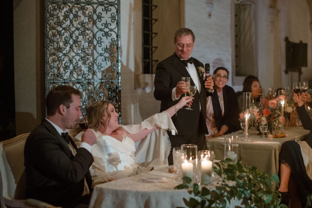 Bride and groom toast at wedding reception