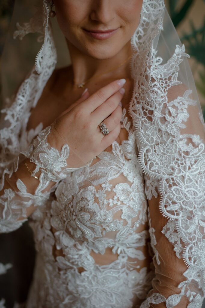 Bridal portrait close up of wedding dress lace details