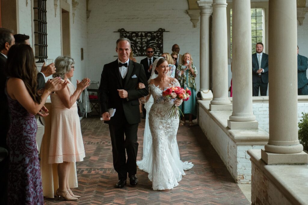 Bride walks with her father to wedding ceremony at Villa Terrace