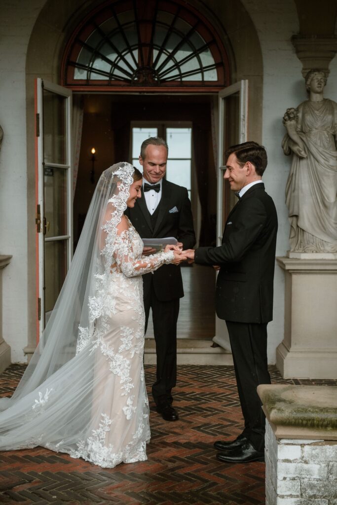 Bride and groom hold hands at Villa Terrace wedding ceremony