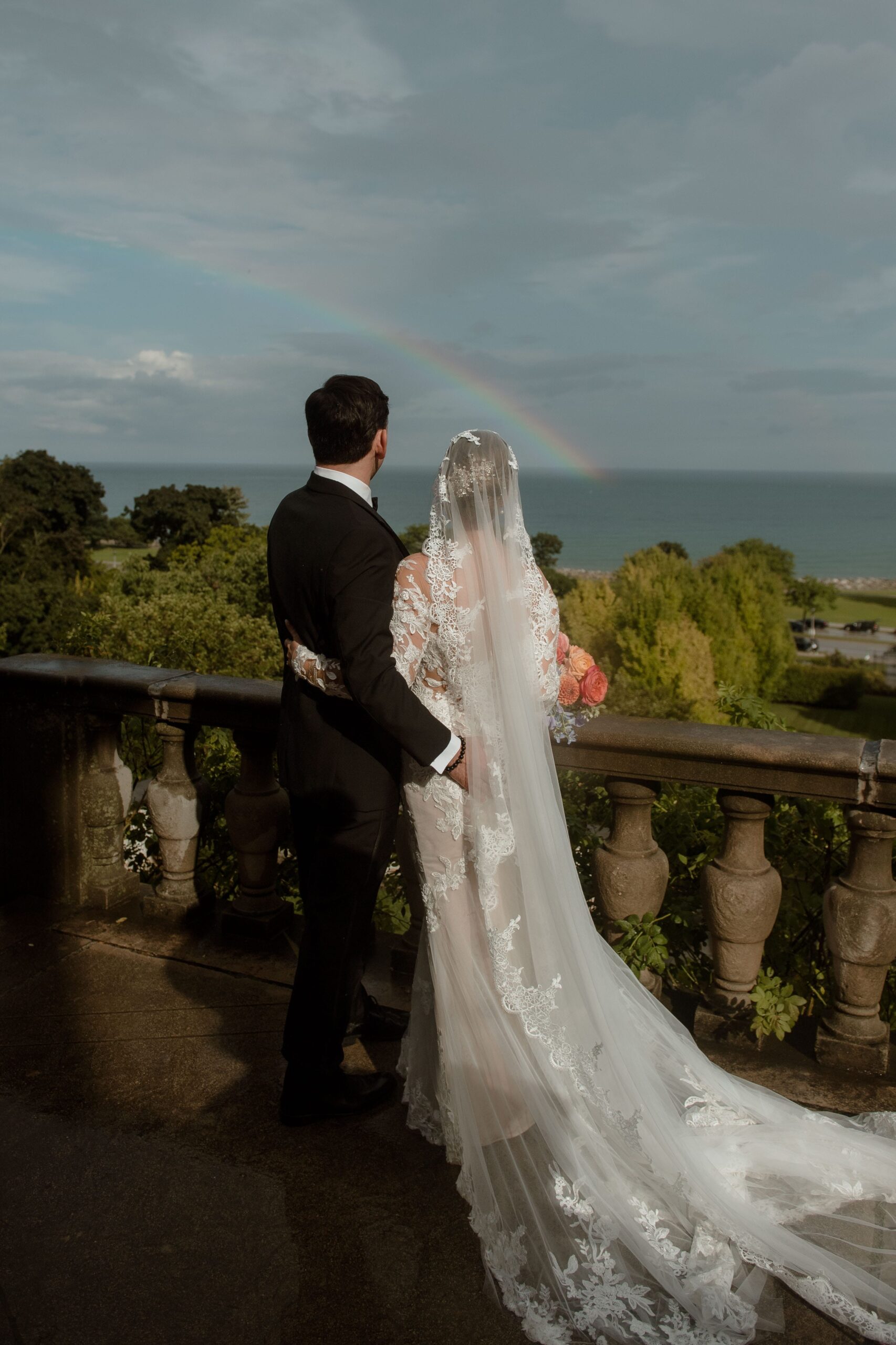 Newly married couple look at rainbow at Villa Terrace