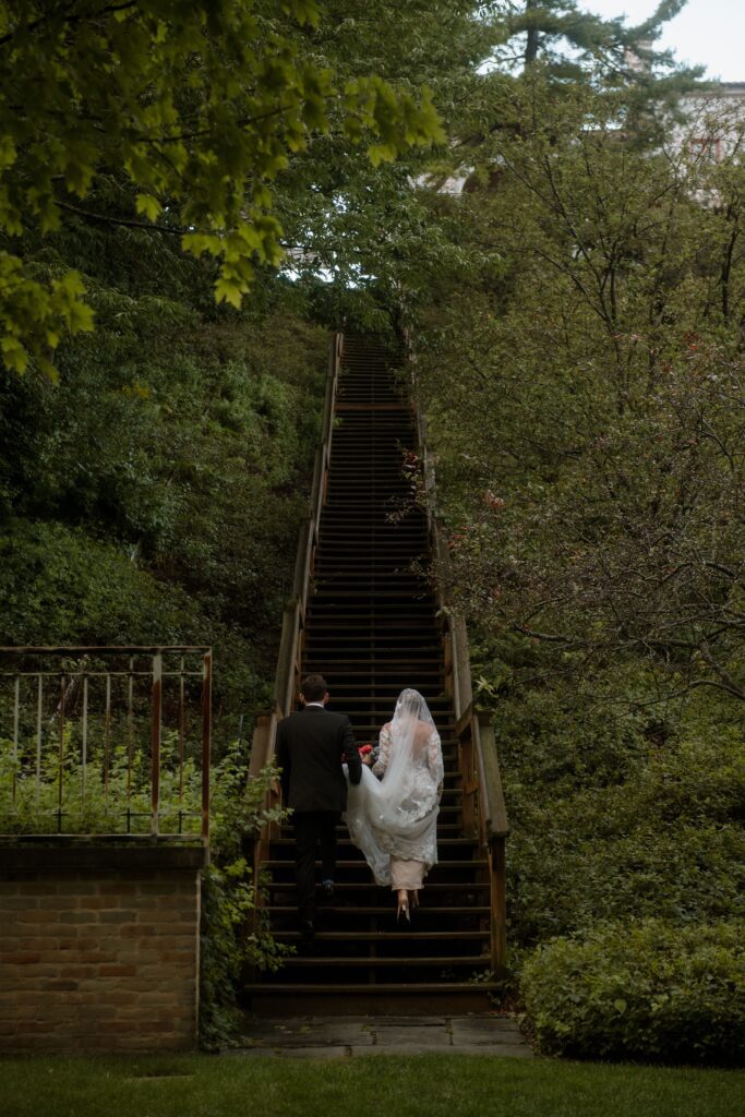 Bride and groom walk up steps at Villa Terrace in Milwaukee