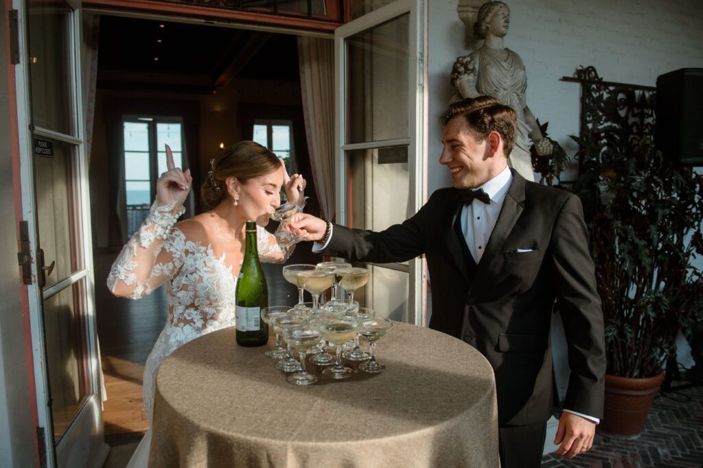 Groom gives bride a drink of champagne at Villa Terrace