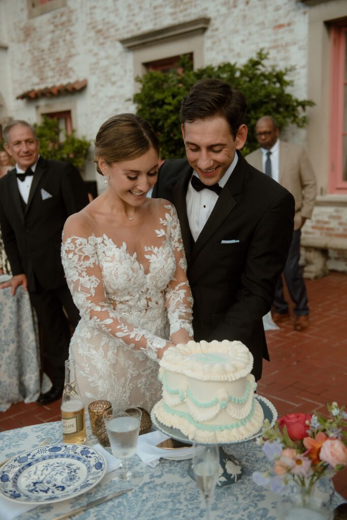 Wedding couple cut their cake by Lucy Bakes at wedding reception