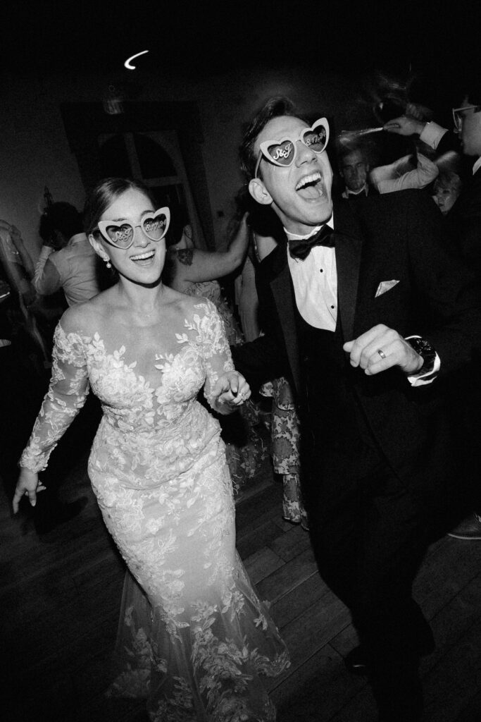 Bride and groom dance in heart shaped glasses at Villa Terrace wedding reception
