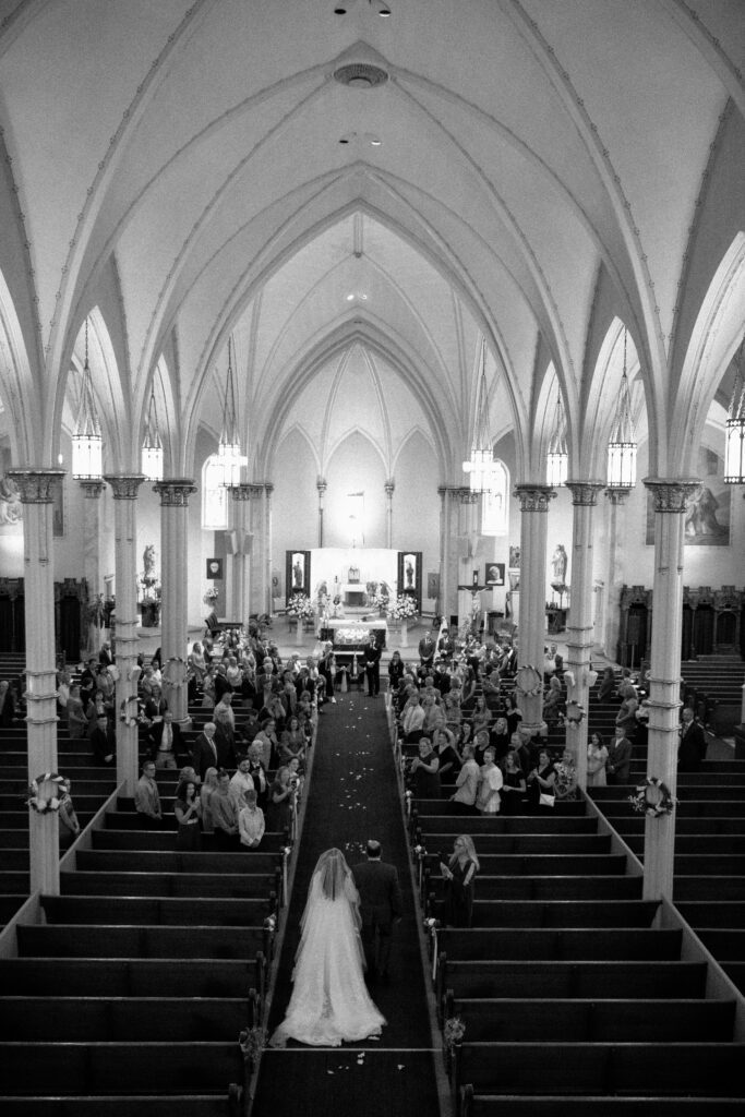 Bride and father walk down the aisle at SS Cyril & Methodius Parish for Polish wedding