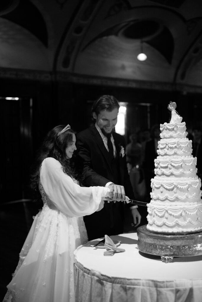 Couple cut their wedding cake at The Wisconsin Club