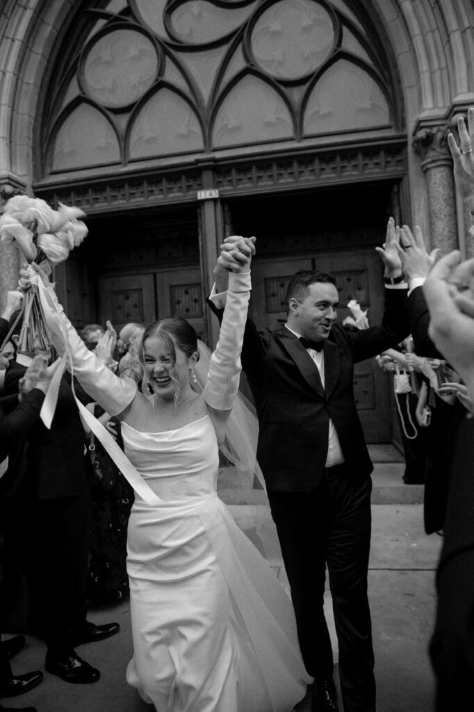 Just married portrait of wedding couple outside Church of Gesu in Milwaukee