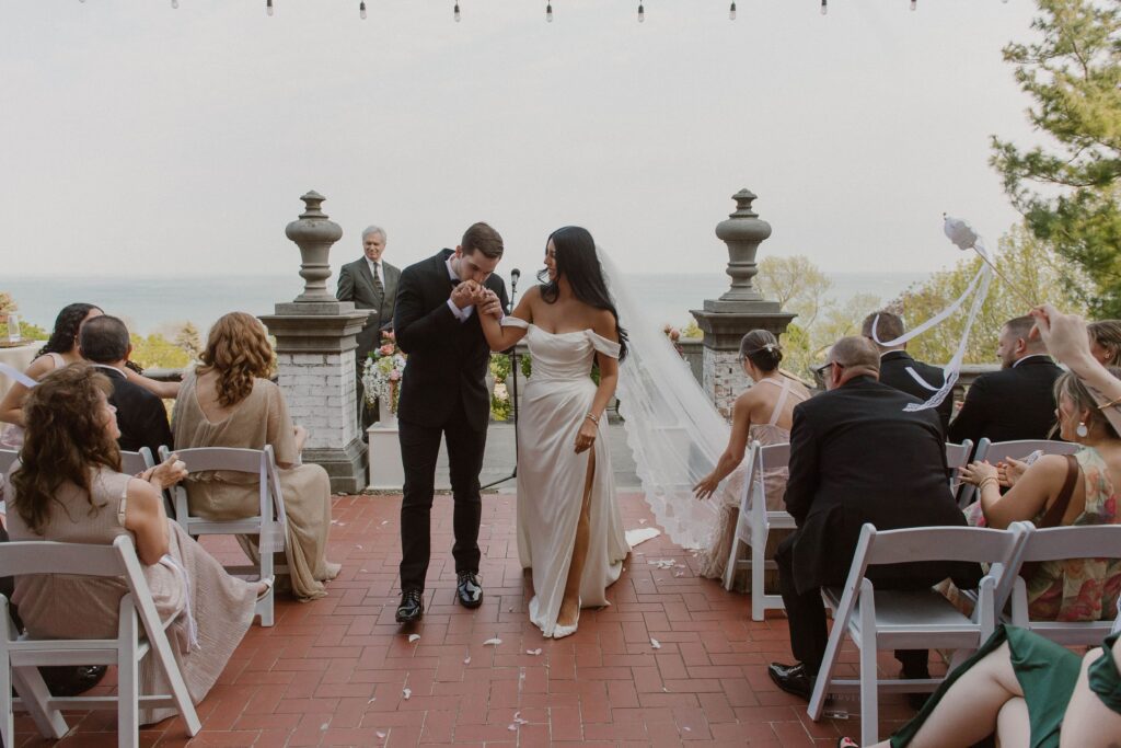 Couple exits their outdoor Villa Terrace wedding ceremony